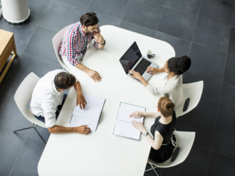 people round a table working